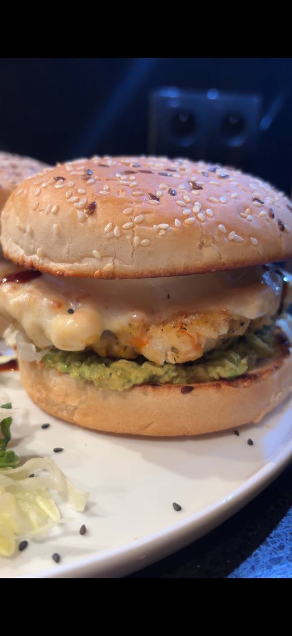 Shrimp burger cross section showing shrimp patty avocado and melted cheese