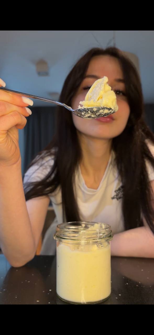 Sofia tasting creamy tropical smoothie bowl with coconut topping